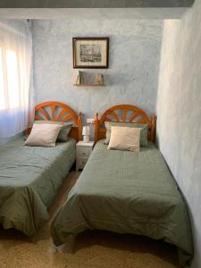 twee bedden naast elkaar in een slaapkamer bij Sagunto in Sagunto