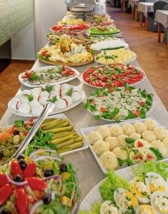 a buffet line of plates of food on a table at Dom Wczasowy Beskidy in Wisła