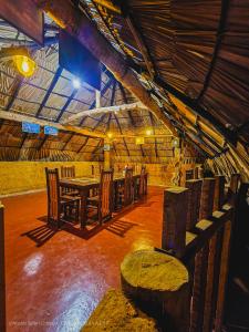 a dining room with a table and chairs in a building at Hasthi Safari Cottage in Udawalawe