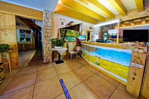 a restaurant with a counter with a fish painting on it at RTA Hotel Le Vallene in Terlago