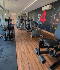 a gym with a row of treadmills and weights at Flat Aguas Claras 218 S4 in Brasilia
