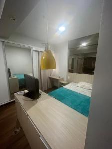 a bedroom with a bed and a laptop on a desk at Flat Aguas Claras 218 S4 in Brasilia