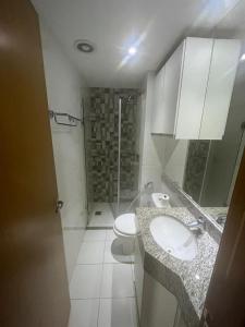 a bathroom with a toilet and a sink and a shower at Flat Aguas Claras 218 S4 in Brasilia