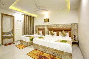 Ліжко або ліжка в номері Gracious by Vishesh Hotels & Home Stay