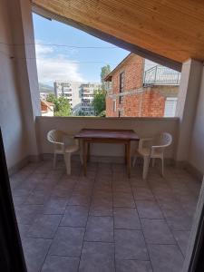 a balcony with a table and chairs and a window at IS Guest House in Ohrid