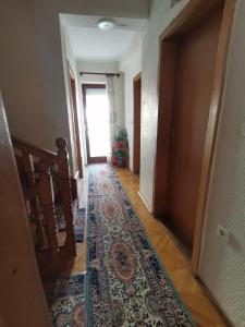 a hallway with a rug on the floor and a door at IS Guest House in Ohrid