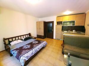 a bedroom with a bed and a kitchen at Golden Dream in Marina Ville in Sveti Vlas