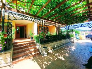 a porch of a house with a pergola at Golden Dream in Marina Ville in Sveti Vlas