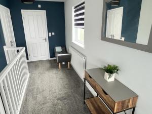 a room with a stairway with a table and a chair at Godrevy Lighthouse View, Carbis Bay, St Ives, free parking, sea view in Carbis Bay