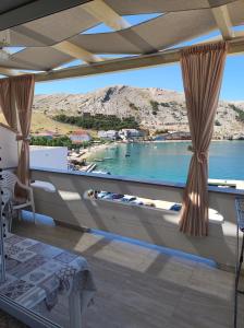 a room with a view of the water at Apartments Katica in Metajna