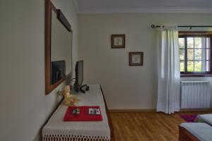 a living room with a table and a mirror at Suite em Viana do Castelo in Viana do Castelo