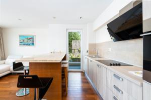 a kitchen with a sink and a counter top at New Five Star Superior Apartment in Zaton