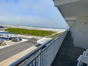 a balcony with a view of a beach and the ocean at Nassau Inn in Wildwood Crest