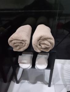 a pair of towels sitting on a shelf at Jennah Spa in Montereau-Fault-Yonne