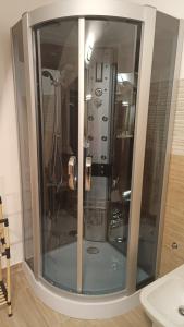 a shower with a glass door in a bathroom at MAISON VENTIMIGLIA 83 in Catania