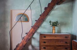 a staircase with a lamp and a dresser in a room at Casale Baldelli Apartments in Castiglione del Lago