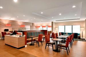 a restaurant with tables and chairs and a counter at TownePlace Suites by Marriott Pittsburgh Airport/Robinson Township in Robinson Township