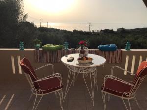 a white table and two chairs on a patio at Ελαίας λειμών in Monemvasia