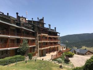 a large building on top of a hill at Apartamento cerca pista de esqui La Molina con piscina y Jardín in La Molina