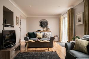 a living room with a couch and a table at End Cottage in Fakenham