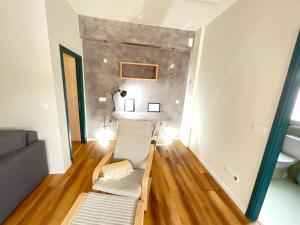 a small room with a couch and a table in it at Apartamento Mouzinho in Horta +48 photos