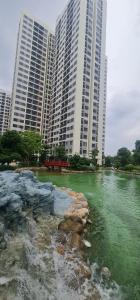 a river in front of two tall buildings at CĂN HỘ VINHOMES GRAND PARK QUẬN 9 Studio in Gò Công