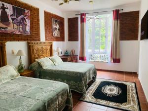 Postel nebo postele na pokoji v ubytování Hotel Boutique Casona Mashei