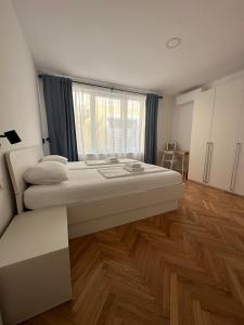 a large bedroom with two beds and a window at Apartments TITO & ROBIN in Koper