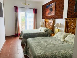 Voodi või voodid majutusasutuse Hotel Boutique Casona Mashei toas