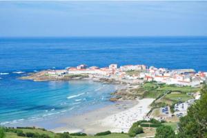 a view of a beach and the ocean at Precioso loft en Caión ROCHA, sobre la arena y el mar in Cayón
