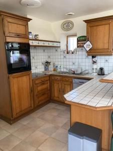 a kitchen with wooden cabinets and a counter top at Villa Mer, Campagne et départ de randonnées in Moëlan-sur-Mer +2 photos