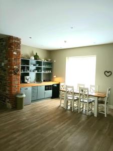 a kitchen and dining room with a table and chairs at Beautiful 2-Bed Apartment near Waterford City in Waterford