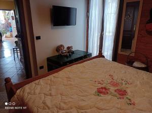 a bedroom with a bed with two dolls on a table at Home Il Cortiglione in Frascati