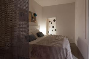 a bedroom with a bed and a mirror at BORGO DEGLI STUDI 7 in Parma +16 photos
