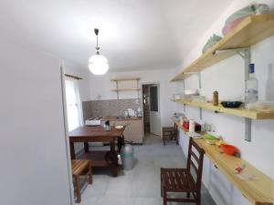 a kitchen and dining room with a table and chairs at Vintage Mediterranean house in Himare