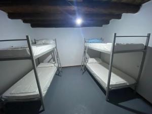 two bunk beds in a room with a ceiling at Vintage Mediterranean house in Himare