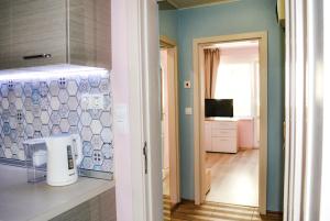 a room with a kitchen with blue walls and a window at Top Location !!FREE parking!! "Belle Mer" Sea Garden, Beach and Promenades in Burgas City +37 photos