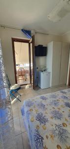 a bedroom with a bed and a room with a kitchen at Villa G&G in Tropea