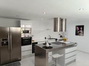 a kitchen with a stainless steel refrigerator and appliances at Maravillosas vistas y el mejor clima del mundo! in La Playa de Arguineguín