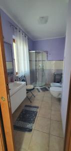a bathroom with a tub and a toilet and a sink at Villa G&G in Tropea +7 photos