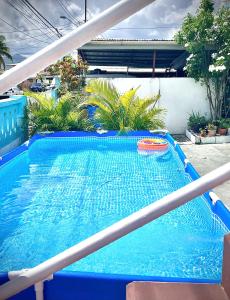 a blue swimming pool with a frisbee on it at Pearls Place in Arima