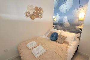 a bed with two pillows on it in a room at Magnifique Studio 2 personnes - VUE MER "La Perle de Jade" in Saint-Michel-Chef-Chef
