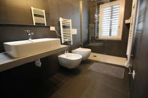a bathroom with a sink and a toilet at Monolocale in Verona