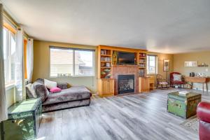 a living room with a couch and a fireplace at Winchester Bay Vacation Rental Near Dunes and ATV! in Reedsport