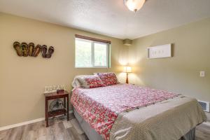 a bedroom with a bed and a window at Winchester Bay Vacation Rental Near Dunes and ATV! in Reedsport