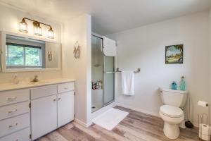 a white bathroom with a toilet and a shower at Winchester Bay Vacation Rental Near Dunes and ATV! in Reedsport +19 photos