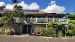 a house with solar panels on the roof at Maui Diver's Dream at Kihei Bay Surf in Kihei