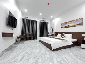 מיטה או מיטות בחדר ב-Khang Hotel