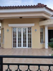 a home with a large patio in front of it at Vasilis House family room in Larnaka +3 photos