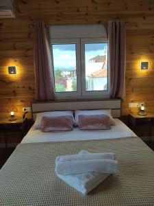 a bedroom with a large bed with a window at Elafonisos Isle B1 in Elafonisos